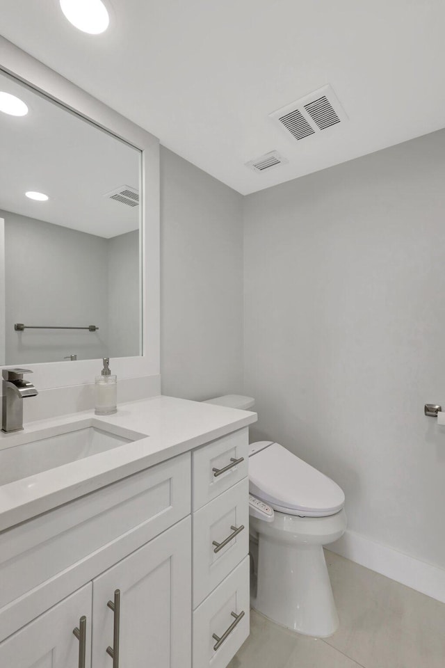 bathroom with vanity, toilet, and tile patterned floors