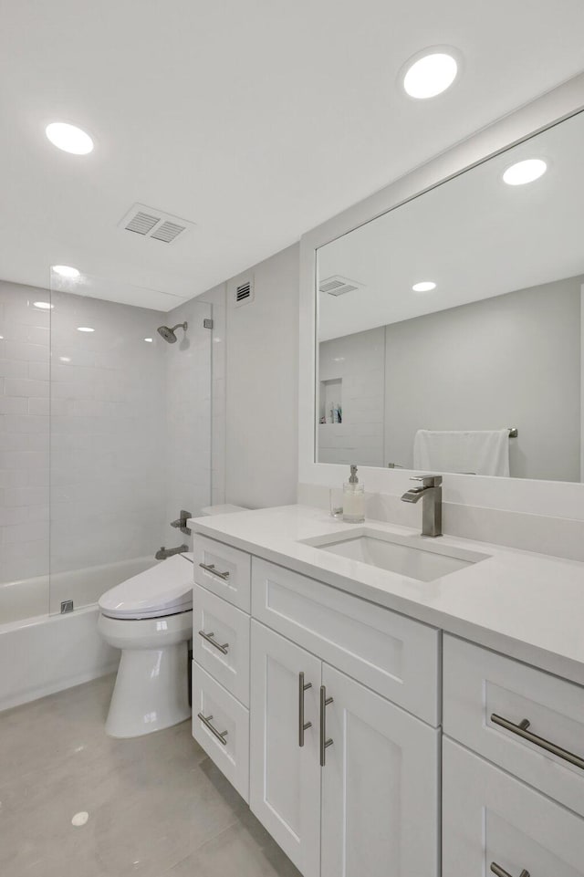 full bathroom with tiled shower / bath, toilet, and vanity