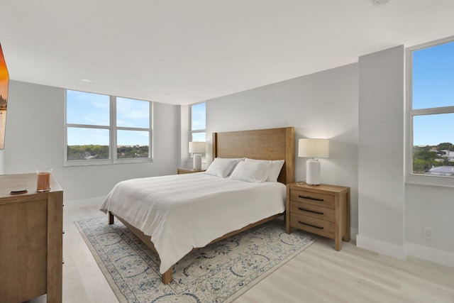 1801 S Flagler Dr Unit 701, West Palm Beach, FL 33401 - bedroom featuring light wood-type flooring, multiple windows, and baseboards