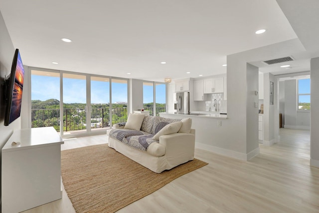 1801 S Flagler Dr Unit 701, West Palm Beach, FL 33401 - living room featuring light wood-type flooring, baseboards, visible vents, and recessed lighting