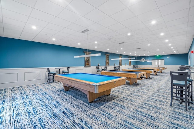 recreation room featuring a paneled ceiling, pool table, and dark colored carpet