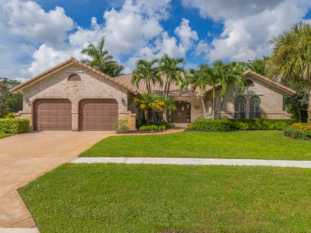 mediterranean / spanish-style house with a garage and a front yard