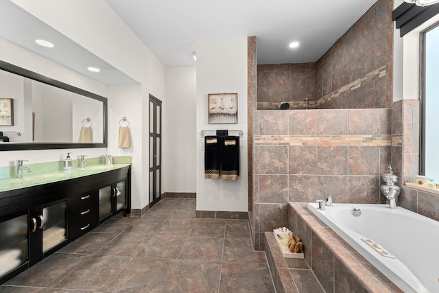 bathroom with tile walls, vanity, and separate shower and tub