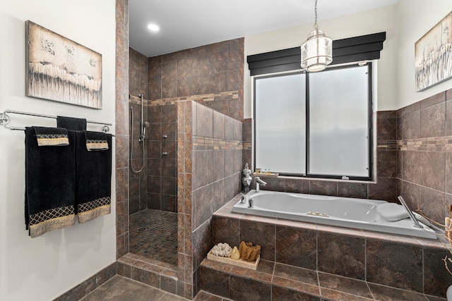 bathroom featuring tile patterned flooring and independent shower and bath