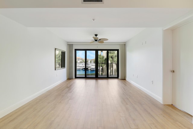 empty room with light wood-type flooring and ceiling fan