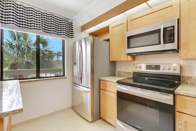 kitchen with light brown cabinets and stainless steel appliances