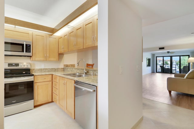 kitchen featuring light brown cabinetry, appliances with stainless steel finishes, light hardwood / wood-style flooring, and french doors