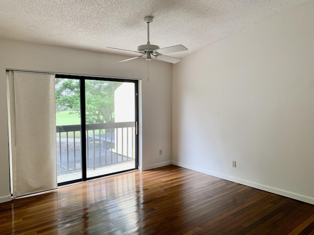 spare room with a textured ceiling, ceiling fan, wood finished floors, and baseboards