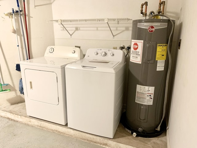 clothes washing area featuring laundry area, water heater, and washing machine and clothes dryer