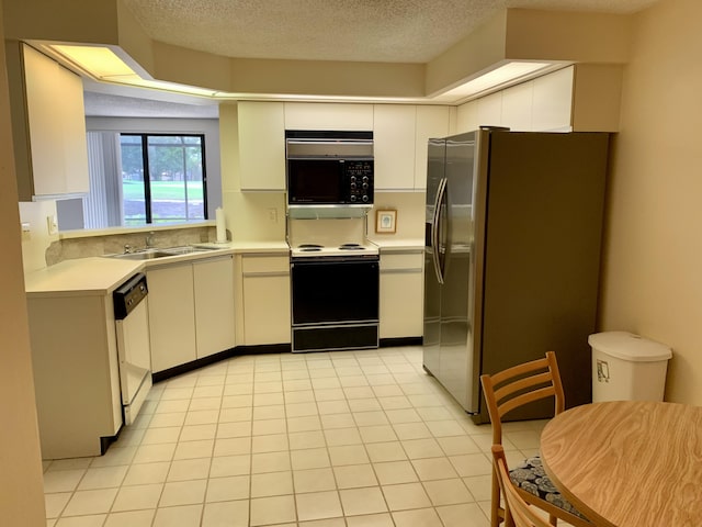 kitchen featuring dishwasher, light countertops, range with electric cooktop, and white cabinetry