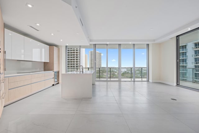 interior space featuring wine cooler, sink, and expansive windows