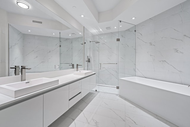 bathroom with vanity, separate shower and tub, and tile walls