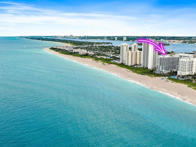 bird's eye view with a water view and a beach view