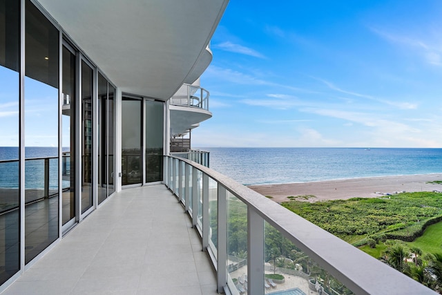 balcony with a water view and a beach view