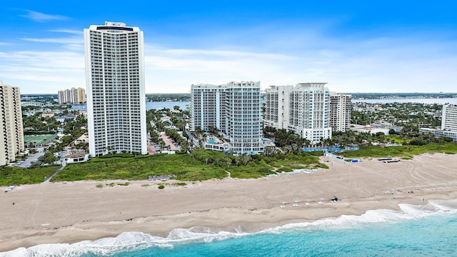 drone / aerial view featuring a water view and a beach view