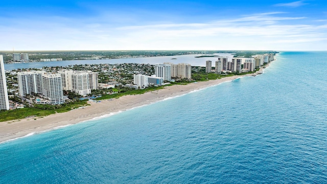 birds eye view of property featuring a water view and a beach view