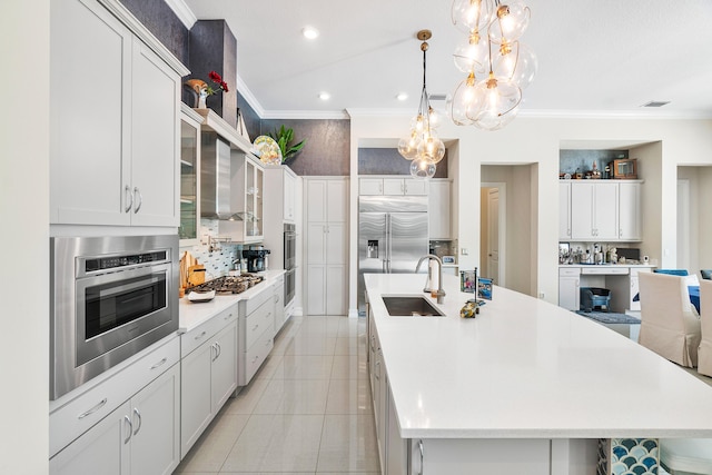 kitchen with a large island, white cabinets, and sink