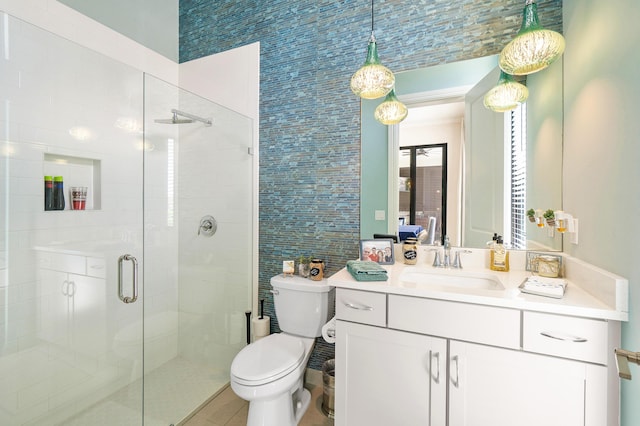 bathroom with walk in shower, tile patterned flooring, vanity, and toilet