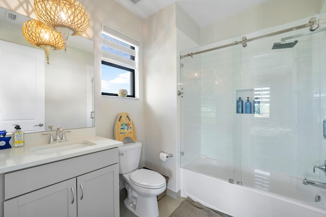 full bathroom featuring toilet, combined bath / shower with glass door, and vanity