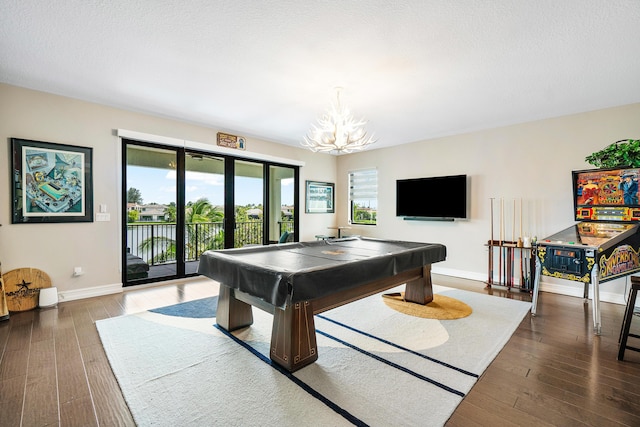 rec room featuring pool table, a notable chandelier, a textured ceiling, and dark hardwood / wood-style floors