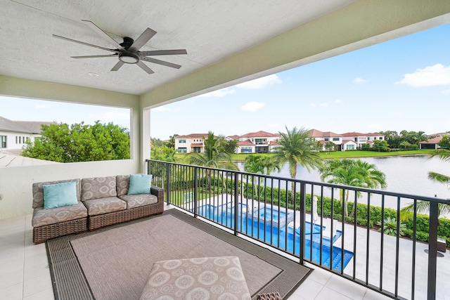 balcony featuring ceiling fan and a water view