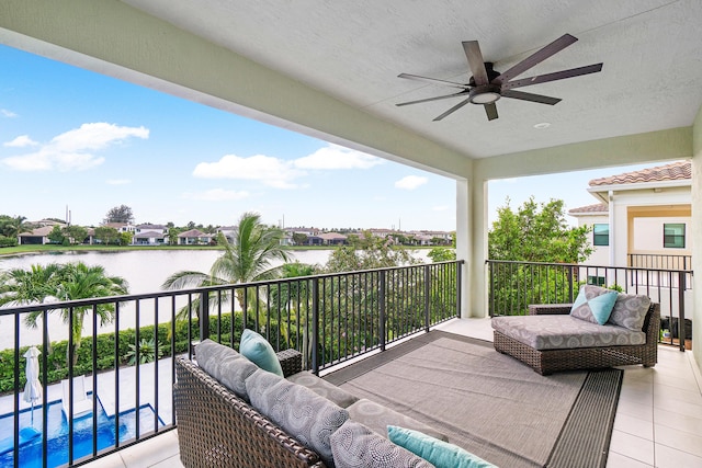 balcony featuring ceiling fan and a water view