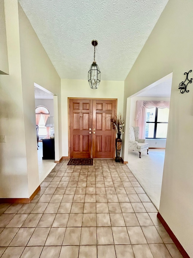 entrance foyer featuring light tile patterned floors and a textured ceiling