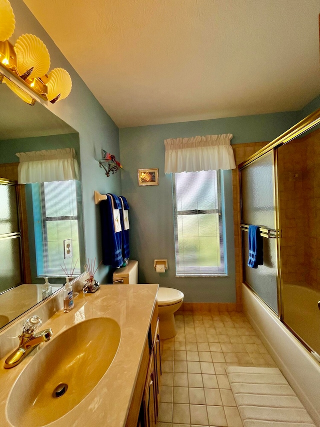 full bathroom with vanity, toilet, enclosed tub / shower combo, and tile patterned flooring