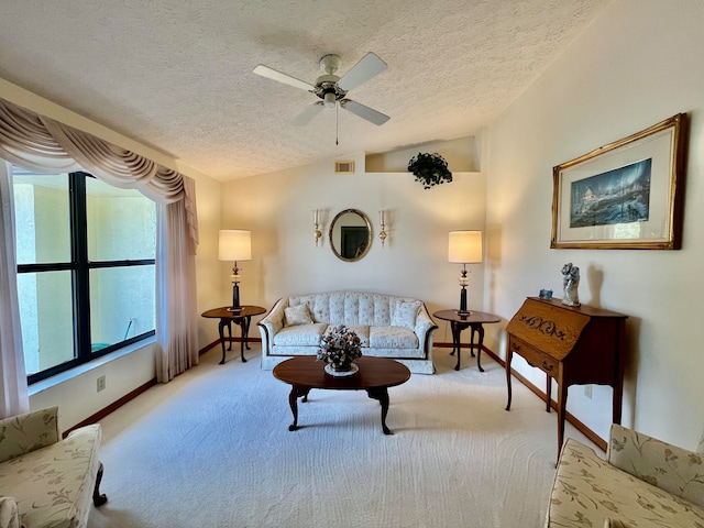 carpeted living room featuring vaulted ceiling, a textured ceiling, and ceiling fan