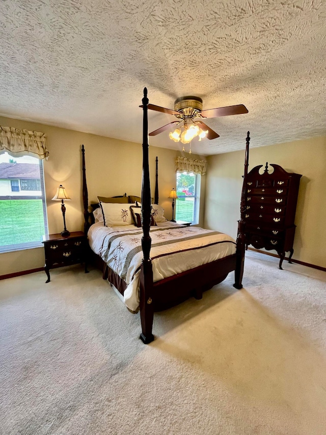 carpeted bedroom with a textured ceiling and ceiling fan