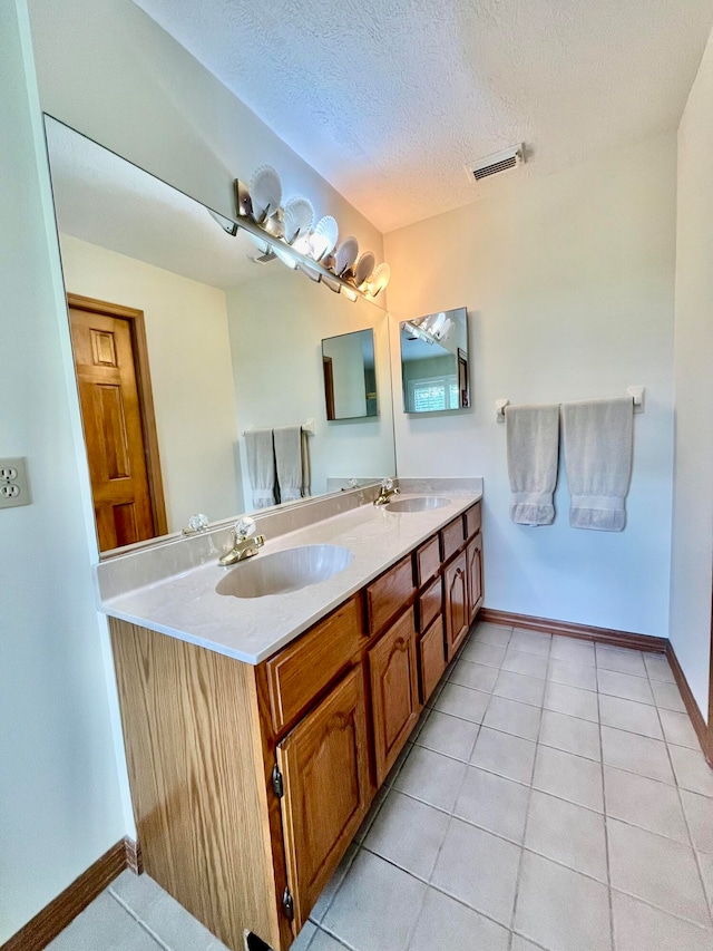 bathroom featuring vanity, a textured ceiling, and tile patterned floors