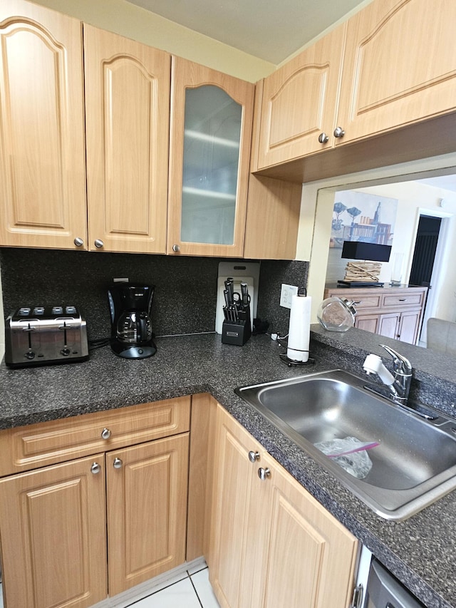 kitchen featuring light tile patterned flooring, sink, light brown cabinets, and tasteful backsplash