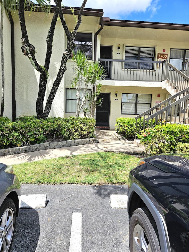 view of front of house featuring a balcony