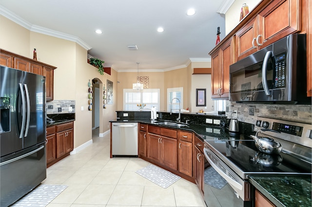 kitchen featuring a chandelier, tasteful backsplash, sink, appliances with stainless steel finishes, and crown molding