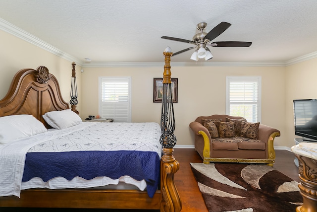 bedroom featuring ceiling fan, ornamental molding, dark wood-type flooring, and multiple windows