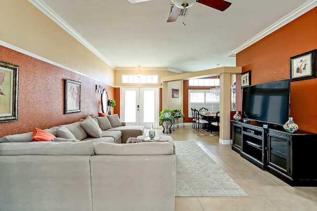 living room with ceiling fan, light tile patterned floors, ornamental molding, french doors, and vaulted ceiling