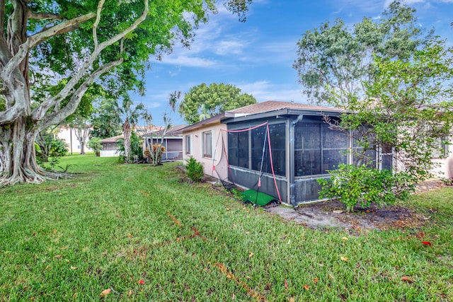 view of yard featuring a sunroom