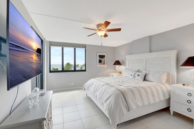 bedroom with light tile patterned floors and ceiling fan