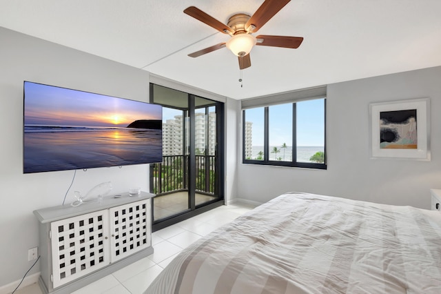 bedroom featuring access to outside, light tile patterned floors, and ceiling fan