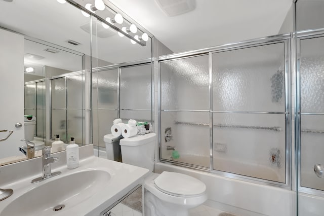 full bathroom with shower / bath combination with glass door, toilet, sink, and tile patterned floors