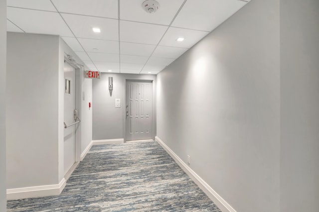 corridor featuring a paneled ceiling