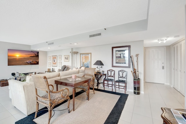 tiled living room with a textured ceiling