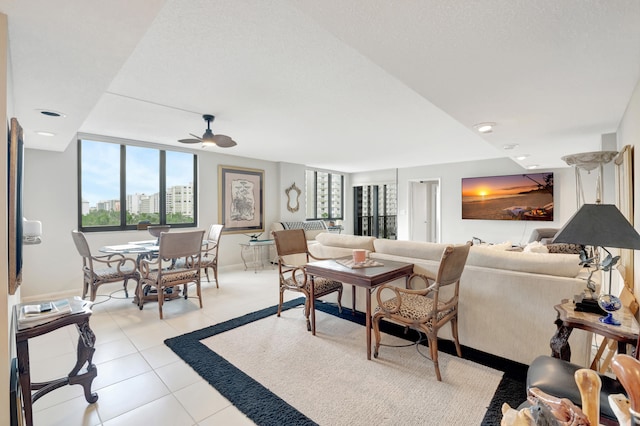 living room featuring light tile patterned floors and ceiling fan