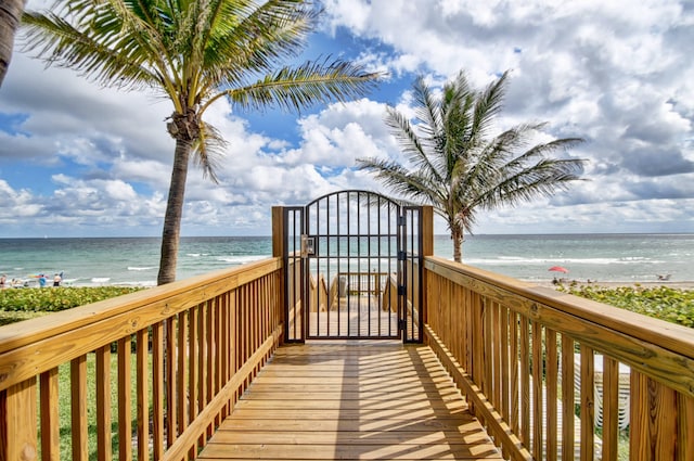 view of community featuring a beach view and a water view