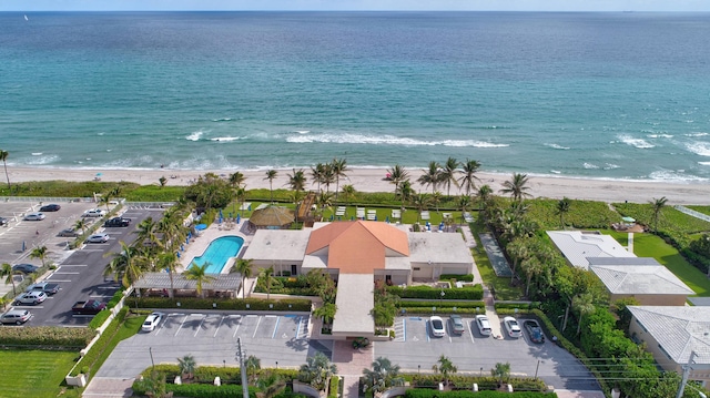 bird's eye view featuring a water view and a beach view