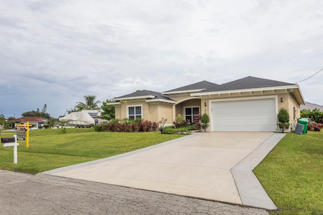 view of front of property featuring a front lawn and a garage