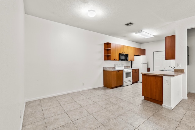 kitchen featuring white appliances, a textured ceiling, light tile patterned floors, kitchen peninsula, and sink