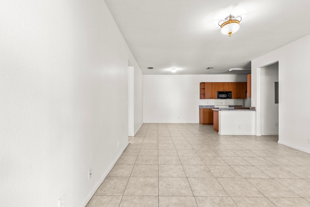 interior space with white range oven, kitchen peninsula, and light tile patterned flooring