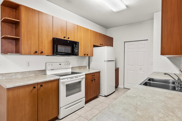 kitchen with a textured ceiling, sink, light tile patterned floors, and white appliances