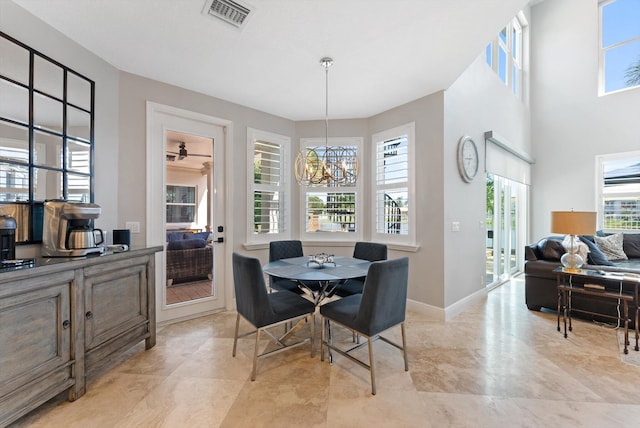 dining space featuring a chandelier, visible vents, and baseboards